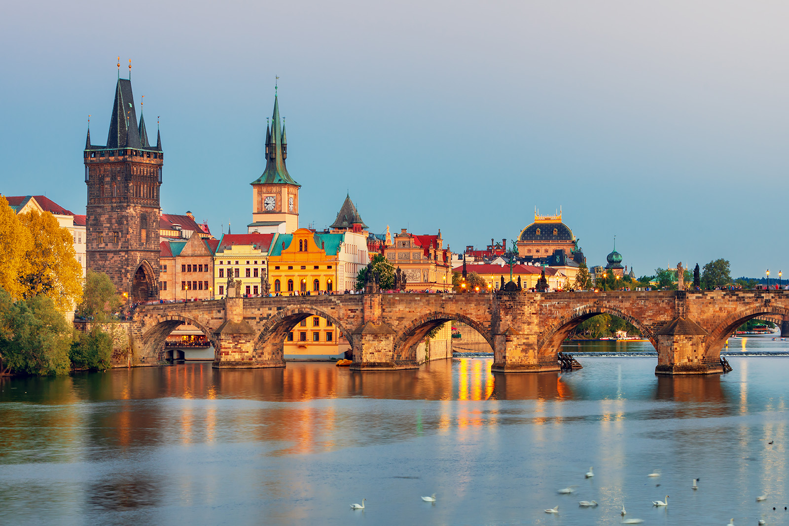 Small town with castle-like buildings and a bridge over a river