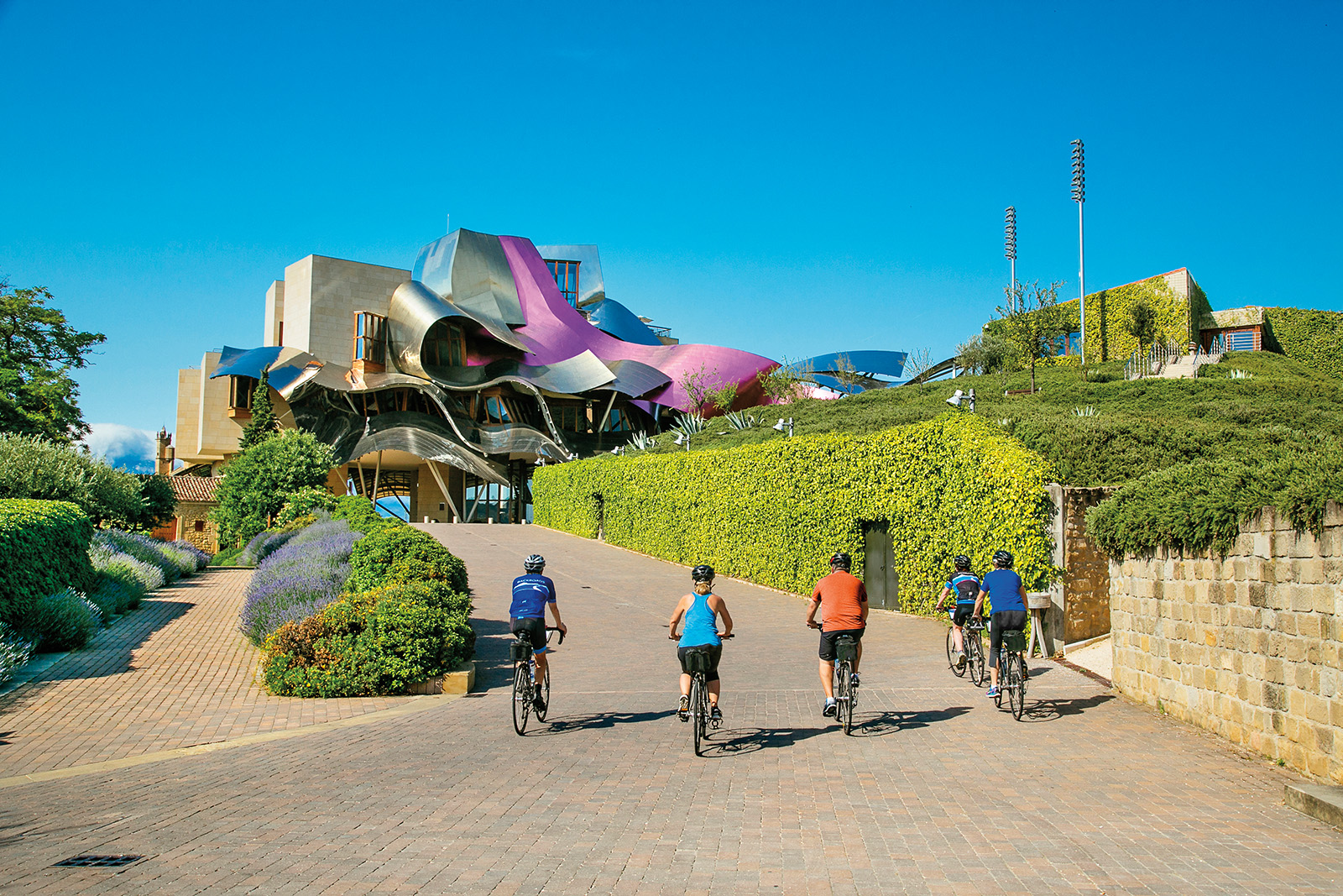 Group of travelers biking up to a colorful building