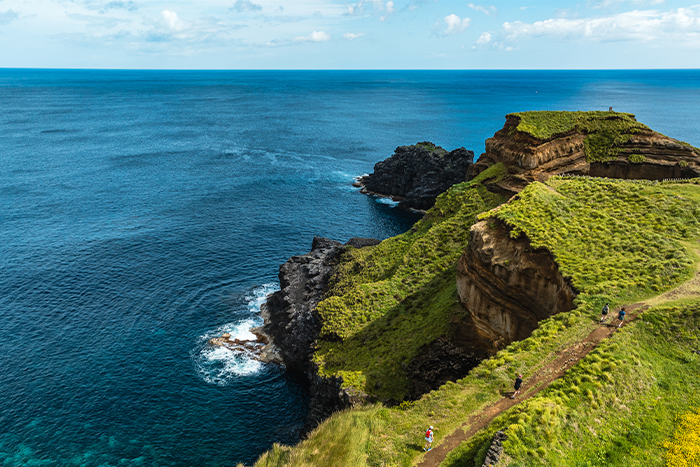steep cliff over blue water
