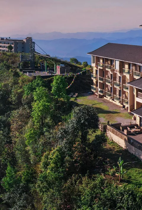 Hotel on a hill covered in trees