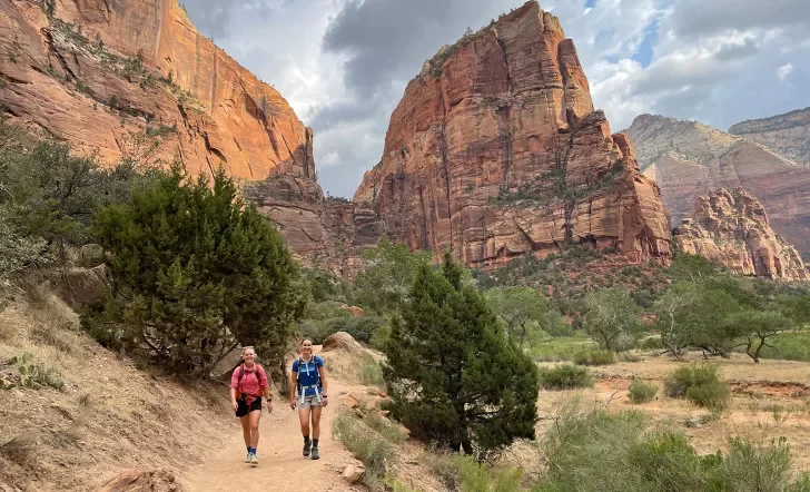 Hikers walking on trail in canyon