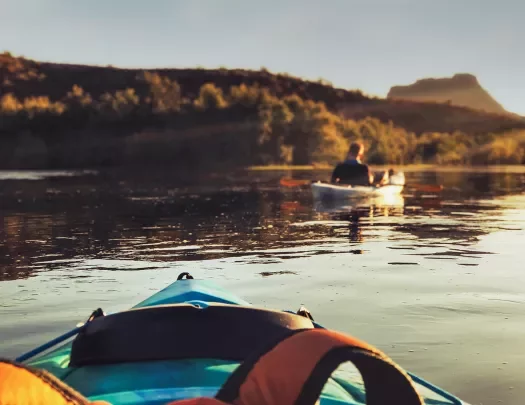 POV shot of kayaking guest, sunset.