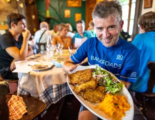Backroads Guest Showing Off Meal in Alsace