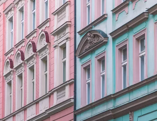 Two Europeans apartment buildings in pastel colors.