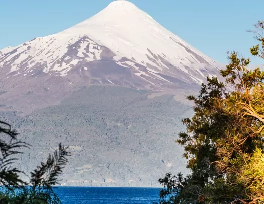 Wide shot of the Osorno volcano, lake below.