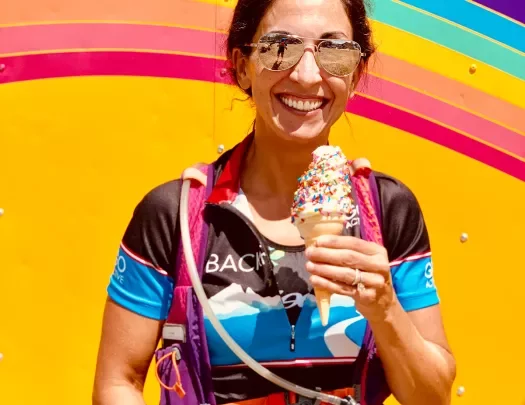 Guest with ice cream standing in front of colorful food-truck.