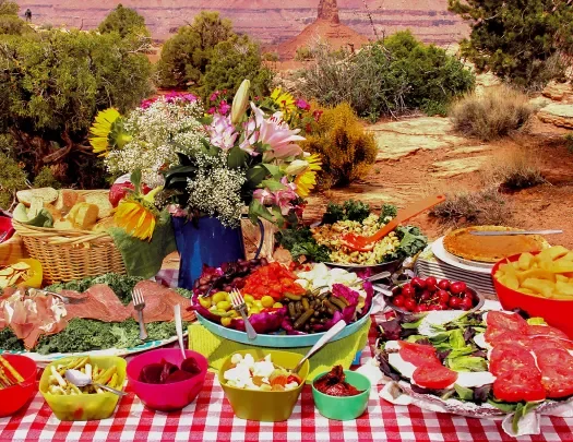 Picnic table spread with mountains in background 