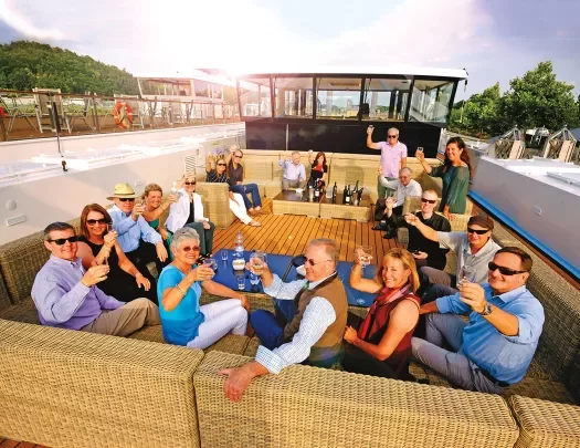 Group of Backroads' guests having happy hour aboard a ship.