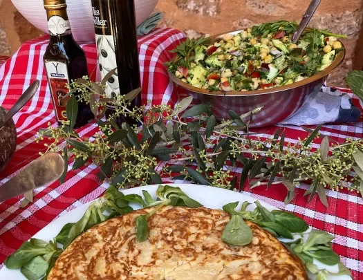 Table with snacks, Spanish tortilla and salad.