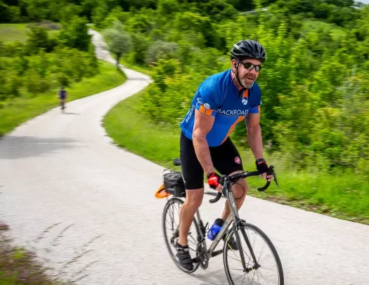 Biking along a winding road in Slovenia