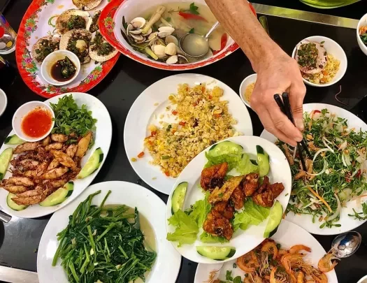 Spread of Vietnamese food, fried rice, meat, seafood, veggies, etc.