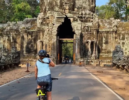 Biker riding toward Angkor Wat in Cambodia