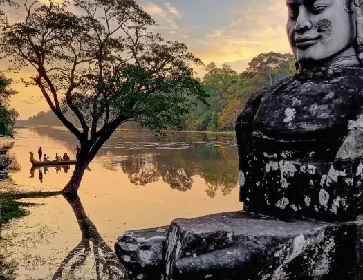 Stone statue of Buddha at sunset
