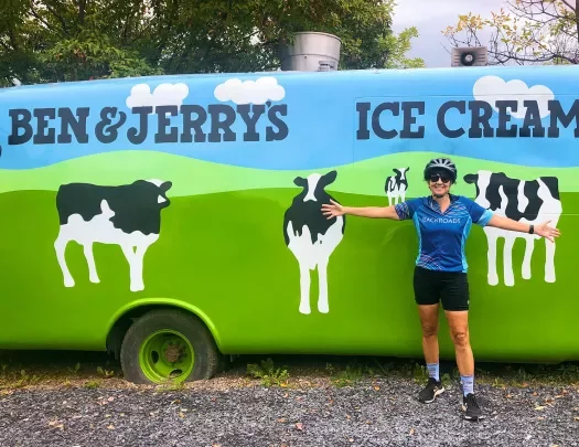 Guest posing in front of Ben & Jerry's car.