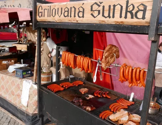 Traditional meats and sausages being sold by a street food vendor