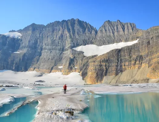 Aquamarine blue lake with snowy mountains and Backroads guest