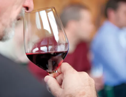 Guest smelling wine in his glass.