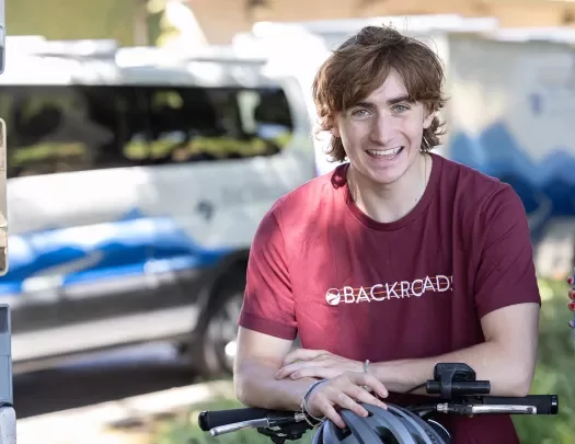 Guest/leader on bike, smiling for camera.