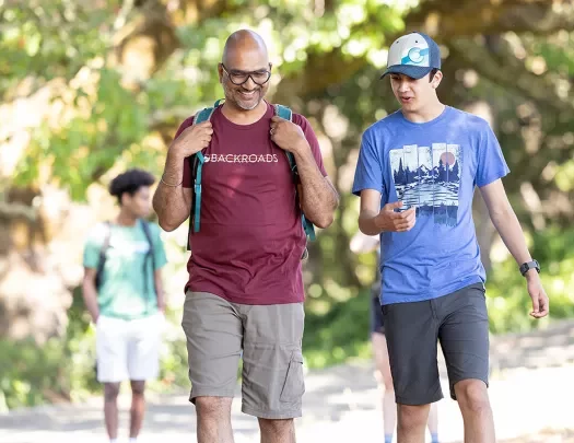 Father and son hiking through a forest