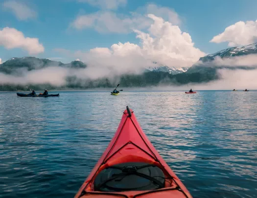 POV shot of guest kayaking, large lake, other guests, clouds etc.