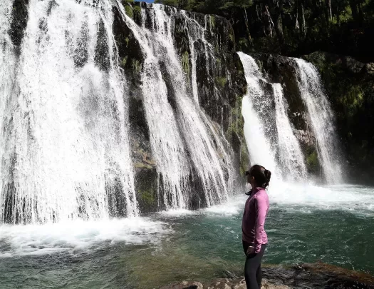 Guest looking at flowing waterfall.