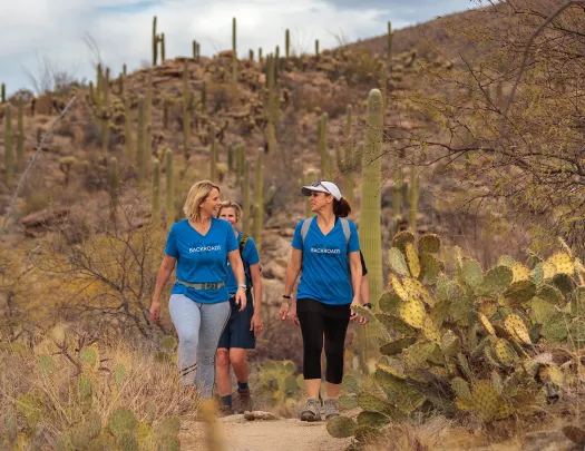 Women hikers in blue backroads shirts talking 