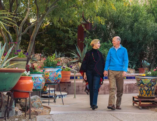 Couple holding hands walking in patio AZ