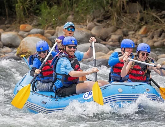 Guests and leader white-water rafting.