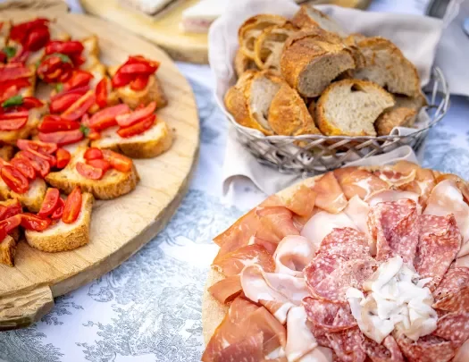 Platter of bread and tomatoes, cured meats, etc.