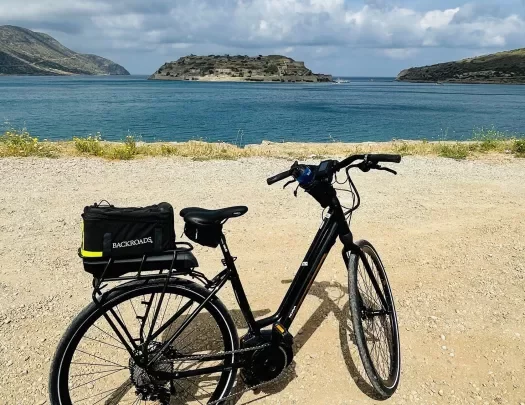 POV shot overlooking ocean, hilly islands, bike in foreground. 