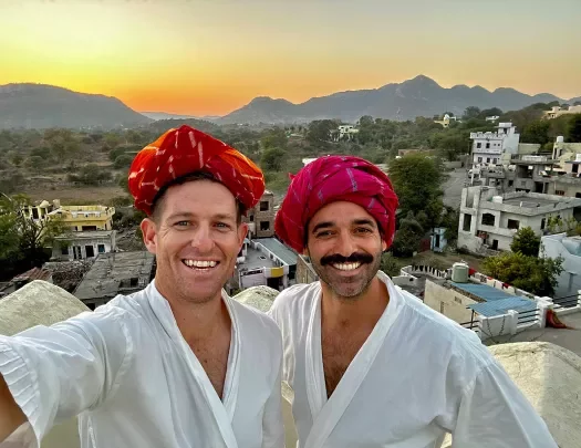 Backroads guests wearing white robes and red turbans in India