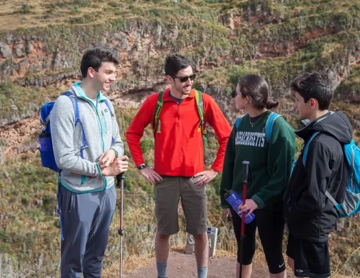 Four guests in hiking gear, talking.