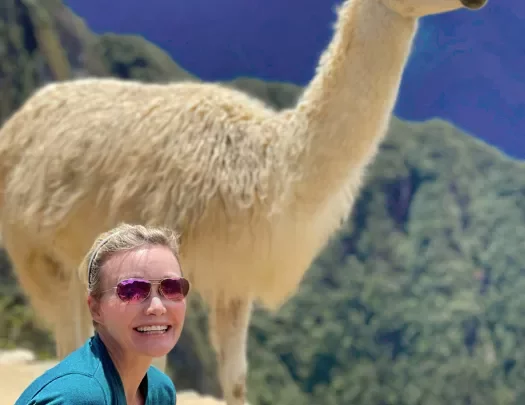 Guest posing in front of alpaca.