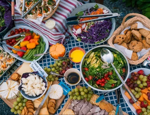 Large lunch spread, salads, veggies, cheeses, cookies, etc.