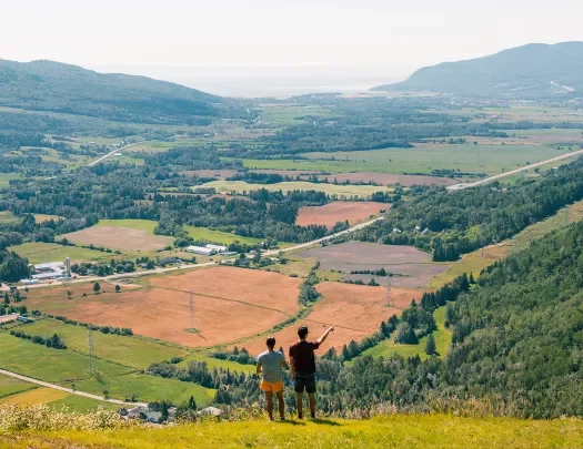 Two hikers overlooking a valley in Quebec, Canada