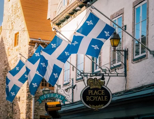 Storefront shot of "PLACE ROYALE", Quebec flags proudly displayed.