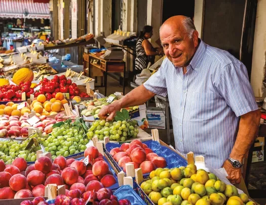 Local fruit vendor, presiding over his booth.