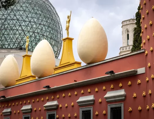 Egg shaped sculptures atop a red building