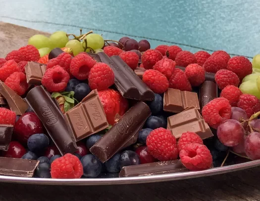 Platter of chocolate, fruit, berries.