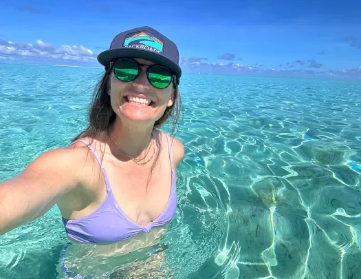 Woman swimming in crystal clear waters in Tahiti