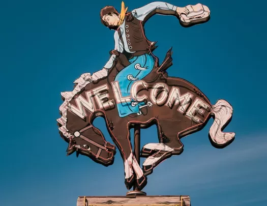 Welcome sign of a Cowboy on a bucking bronco 
