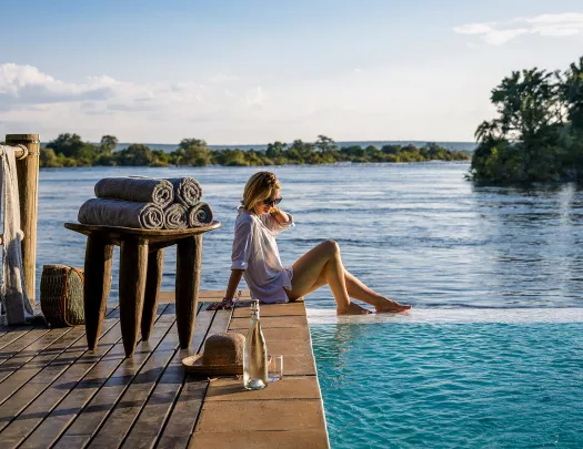 Woman with her feet in the water at Sanctuary Sussi & Chuma