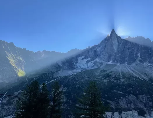 Shot of large mountain eclipsing sun, camera is in shadow.