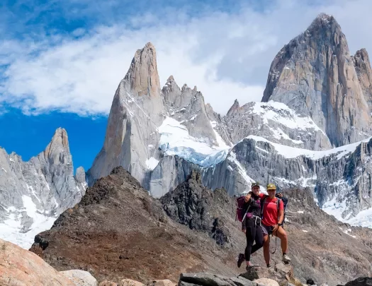 Two hikers posing on top of a rock in Patagonia.