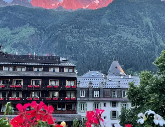 Point of view shot of Chamonix Mont Blanc, sunset illuminating mountaintops.