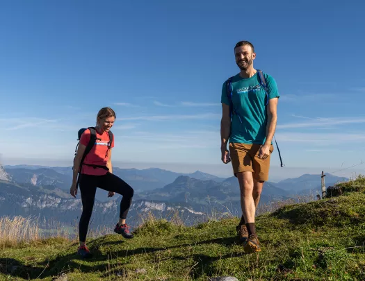 Two hikers on top of a hill. 