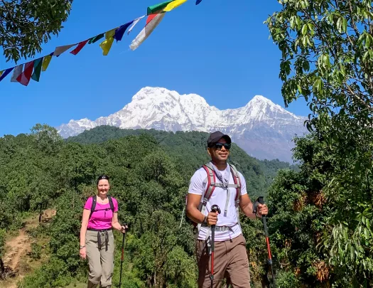 Hiking along a dirt path with mountains in the background in Nepal