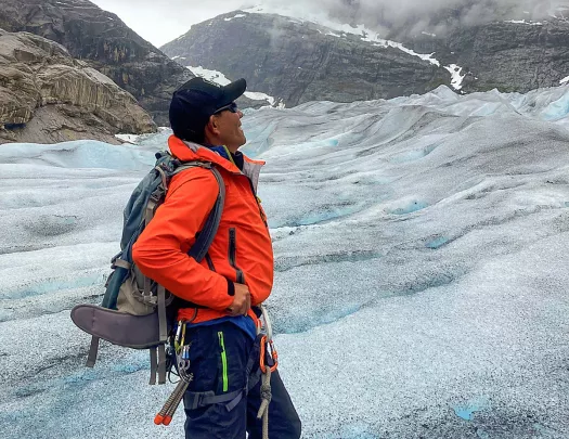 Solo hiker gazing out on a glacier