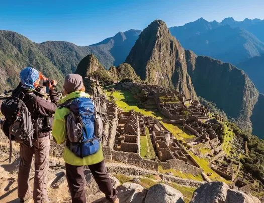 Two guests overlooking Machu Picchu vista.