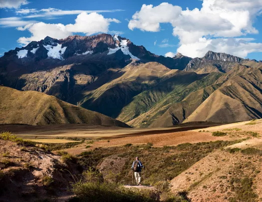 Wide shot of South American mountain range, guest visible in distance.